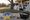 Decorative star, balloon, and gift-shaped yard signs stand beside installation tools on a driveway.