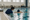 Swim instructor supports a child practicing in an indoor pool.