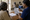 A woman reviews an illustrated information sheet with a healthcare worker at a clinic desk.