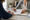 A clinician and patient review paperwork together at a desk in an office.