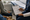 Healthcare professional reviews a clipboard with two seated people in an examination room.