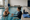Two women talk during a one-on-one swim lesson in an indoor pool.