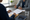 Clinician and patient review paperwork together at a desk, with glasses and water nearby.