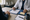 A clinician reviews paperwork with a seated patient across a desk during a consultation.