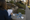 Woman writes on a clipboard beside star and speech-bubble-shaped sign pieces on a concrete ledge.
